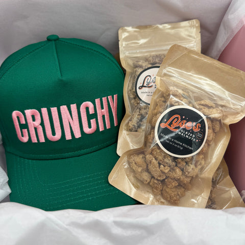 Green cap with 'CRUNCHY' text and a package of glazed pecans and walnuts  on a white background